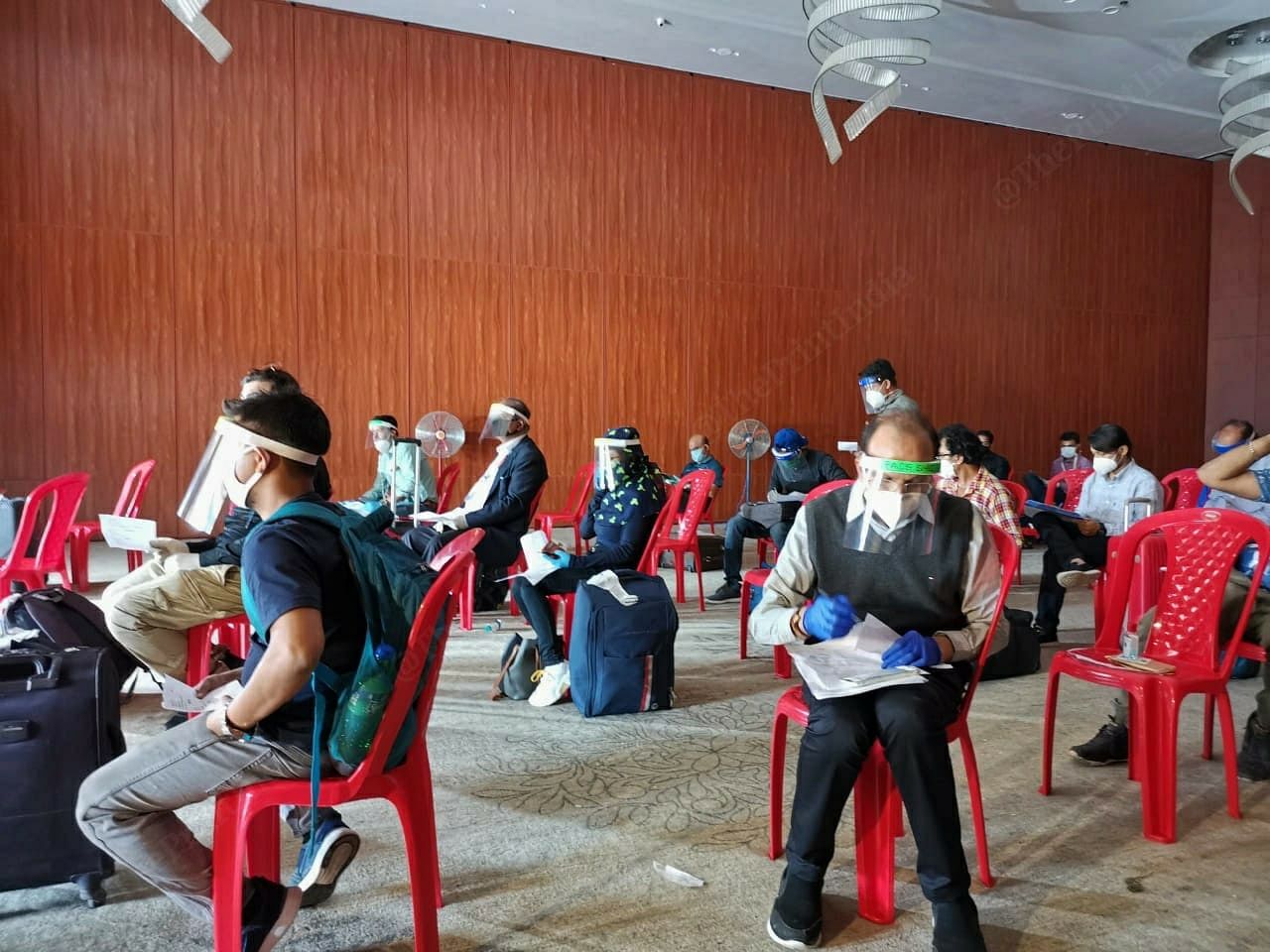 Passengers coming in via flights, are taken to the screening centres like this one at Kiranshree Grand Hotel. They are then asked to fill out forms with their details including their house addresses and comorbidities.| Photo: Angana Chakrabarti | ThePrint