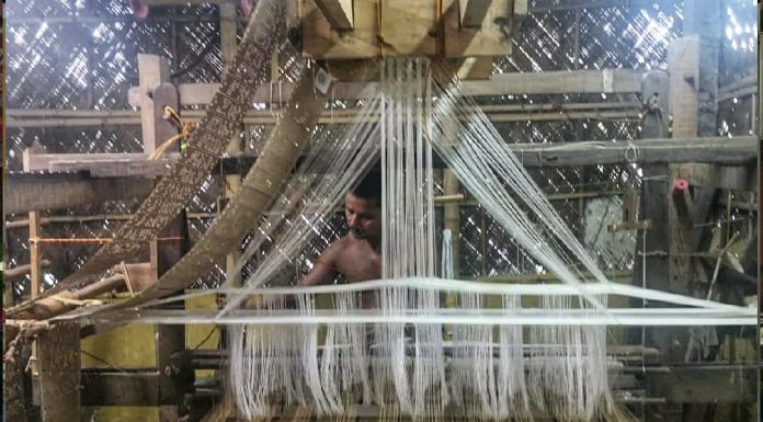 A few handlooms are still at work in Sualkuchi, which has been badly hit by the Covid crisis. Here, a weaver makes a traditional Assamese mekhala-sador | Angana Chakrabarti | ThePrint