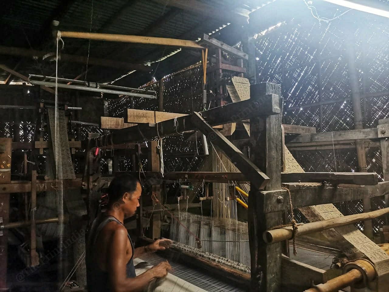 Inside a handloom facility in Sualkuchi. As a result of the depleted demand, weavers only have enough work for a few hours a day. A typical busy day would usually last around 12 hours | Angana Chakrabarti | ThePrint