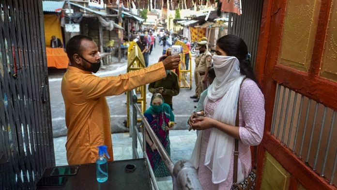 People undergo thermal screening at Mankameshwar temple in Lucknow after all religious places were reopened with certain restrictions on 8 June 2020 | Nand Kumar | PTI