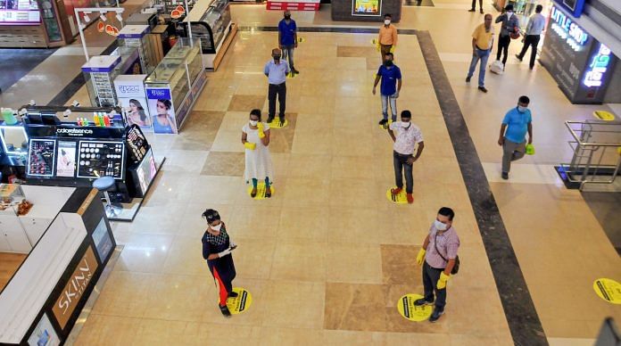 File photo | Shoppers maintain social distance while standing in a queue at Lake Mall, Kolkata | PTI