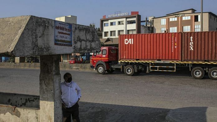 A truck transports shipping containers from the Jawaharlal Nehru Port, operated by Jawaharlal Nehru Port Trust (JNPT), in Navi Mumbai, Maharashtra on Monday, March 30, 2020. | Photographer: Dhiraj Singh | Bloomberg
