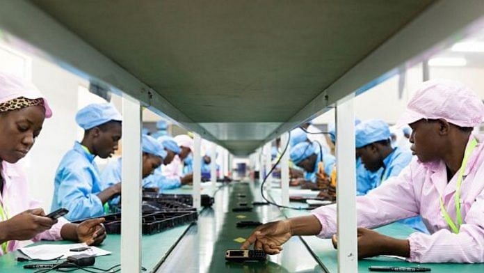 Ugandan factory workers assemble mobile phone parts on the production line on December 02, 2019 in Namanve, Uganda | Luke Dray | Getty Images via Bloomberg file