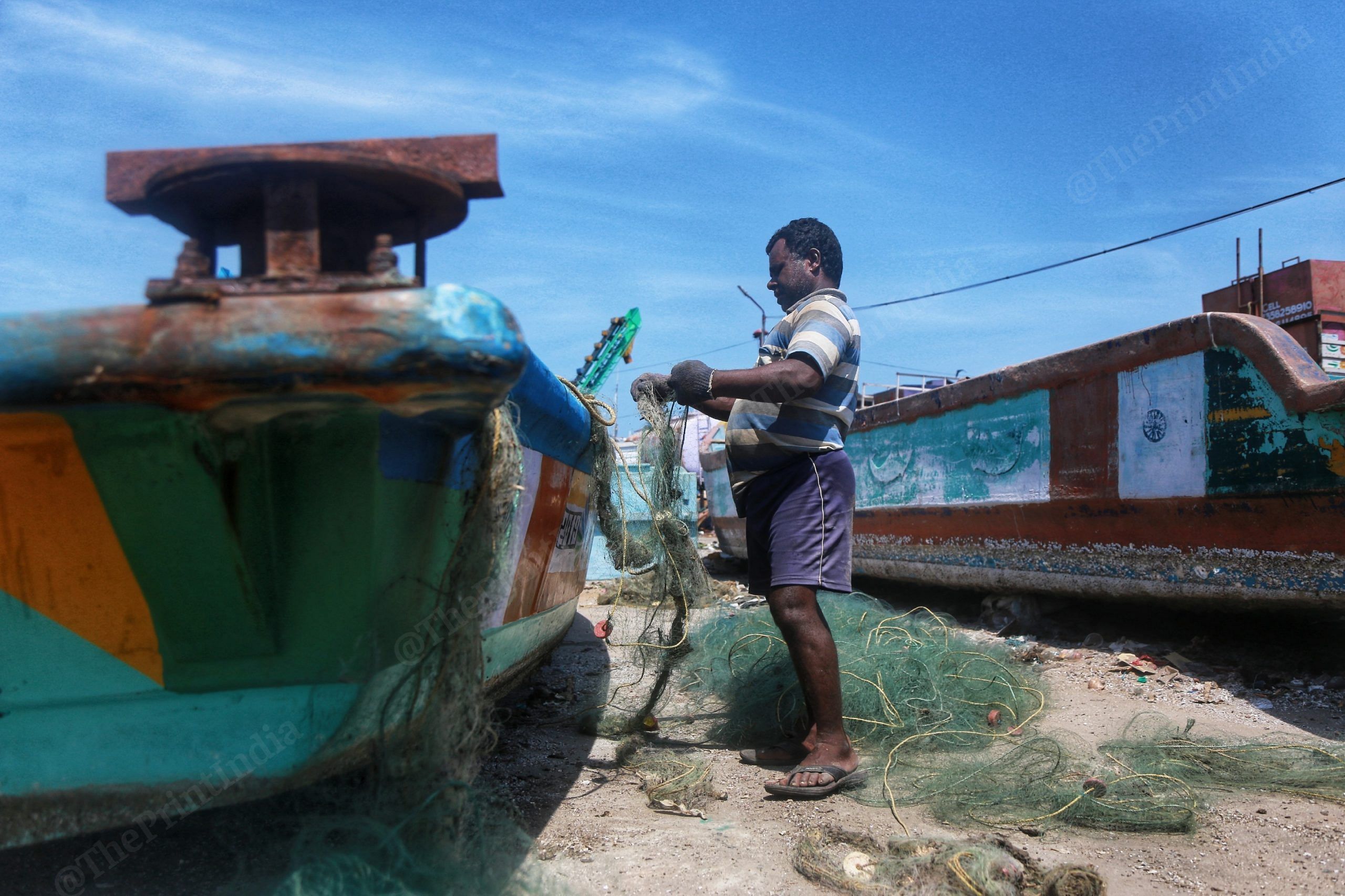 A fisherman sorts out his nets | Manisha Mondal | ThePrint