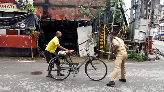 A policeman deals with man who was violating lockdown norms in Guwahati on 25 June
