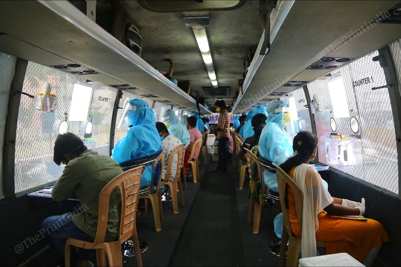 Lab technicians and doctors seated inside the mobile testing facility | Suraj Singh Bisht | ThePrint
