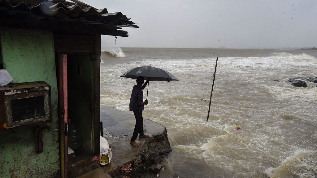A man stands near a shanty built on the edge of the Arabian Sea at Bandra, as the waves turn choppy ahead of Cyclone Nisarga expected landfall, in Mumbai | PTI
