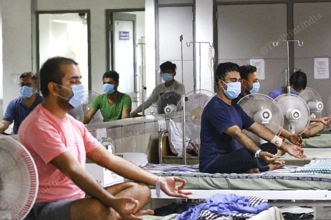 Covid-19 patients doing meditation in the ward | Photo: Praveen Jain | ThePrint