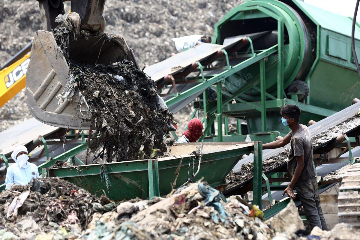The bulldozer dumps the waste in the machine, where it is turned into manure | Suraj Singh Bisht | ThePrint