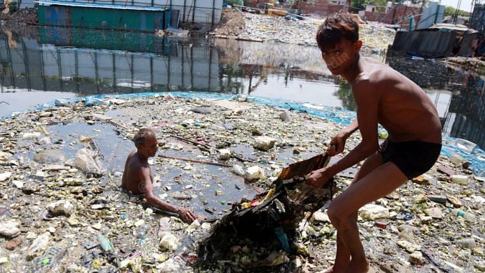Divers at the WHO construction site pull out all waste | Photo: Manisha Mondal | ThePrint