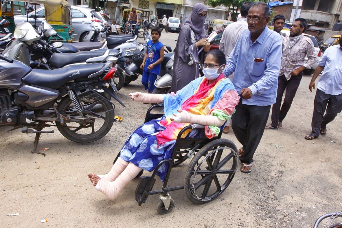 Misbah is taken into her house on a wheelchair. She is well enough to be discharged from the hospital, but will take time to be fully recovered | Praveen Jain | ThePrint