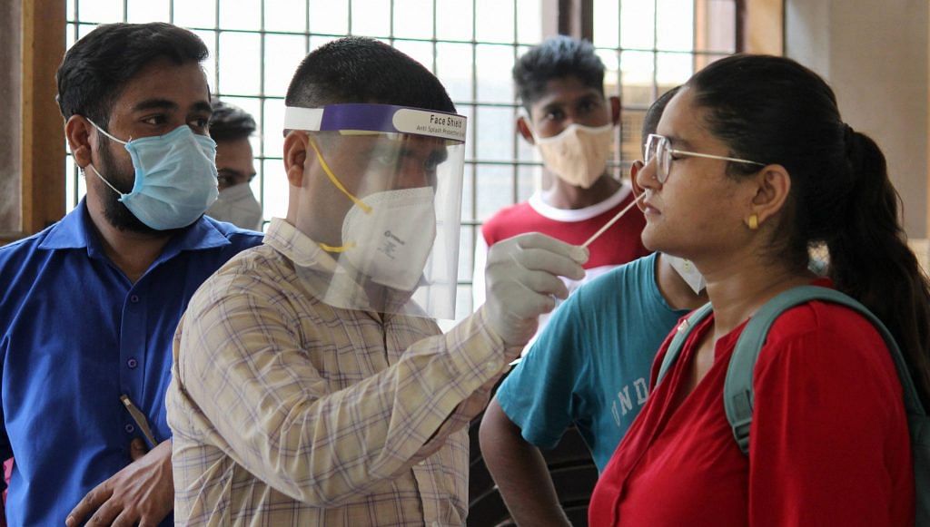 A health worker collects a sample of a patient in Gurugram Saturday, July 4, 2020. | PTI