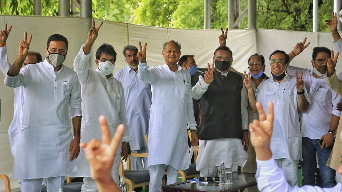 Rajasthan Chief Minister Ashok Gehlot (C) with senior Congress leaders Randeep Surjewala, Avinash Pandey, Ajay Maken and K.C. Venugopal flashes victory sign during a meeting with the party MLAs at his residence in Jaipur, Monday, 13 July, 2020. | PTI