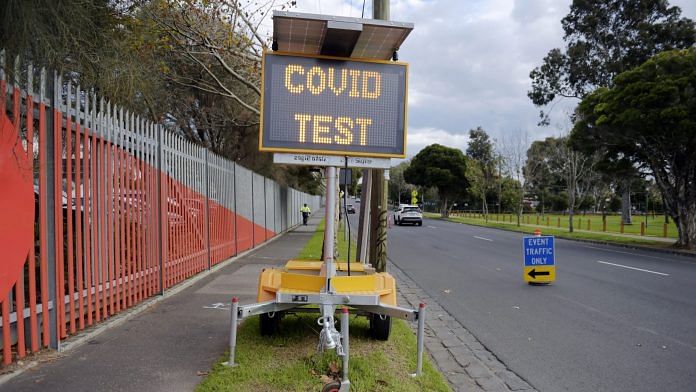 A road sign directs people to a drive-in Covid-19 testing site set up at the Melbourne Show Grounds in Melbourne | Photographer: Carla Gottgens | Bloomberg