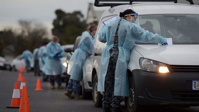 Australian Defence Force gather information and conduct temperature checks at a drive-in Covid-19 testing site set up at the Melbourne Show Grounds in Melbourne | Photographer: Carla Gottgens/Bloomberg