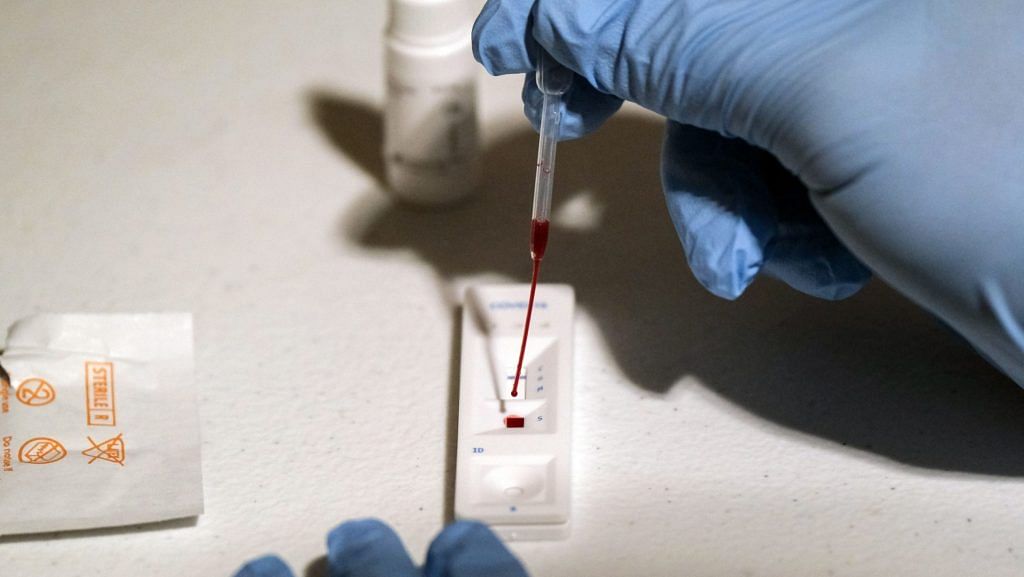 A medical worker performs Covid-19 testing. | Photographer: Gabriella N. Baez | Bloomberg