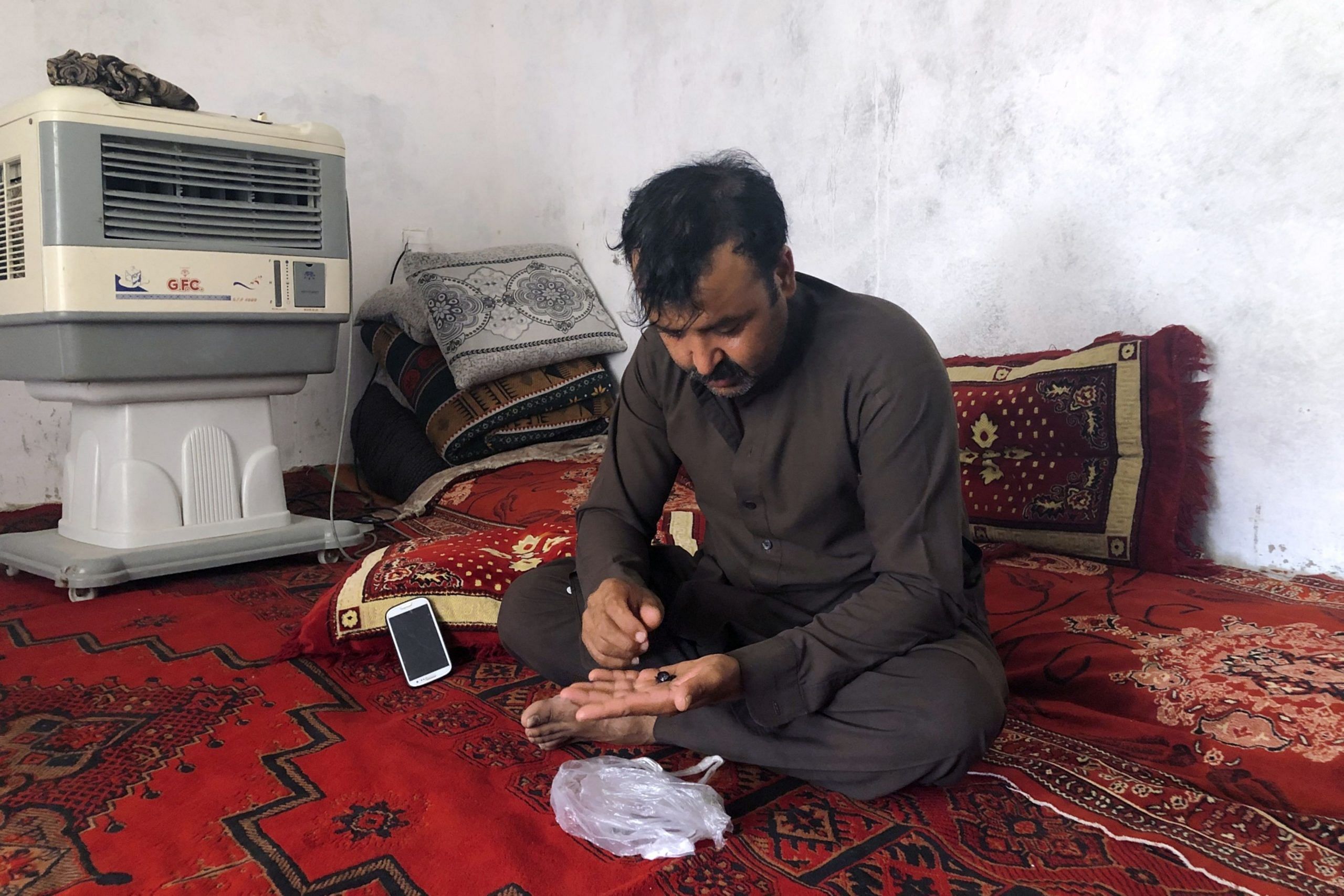 Mohammad prepares opium at his home 
