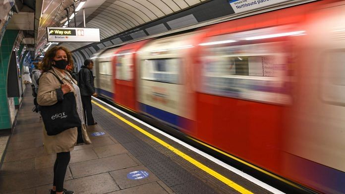 Commuters wear face masks as they use the London Underground | Peter Summers | Getty Images via Bloomberg