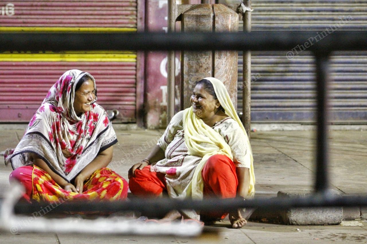 Two women talk outside the closed shops in Ahmedabad | Photo: Praveen Jain | ThePrint