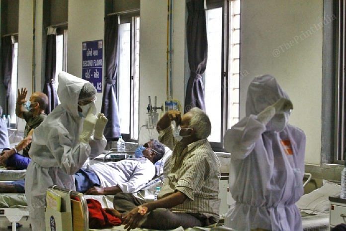 A counsellor teaches a Covid-19 patient some yoga aasans in the Covid-19 ward of the Civil Hospital | Photo: Praveen Jain | ThePrint