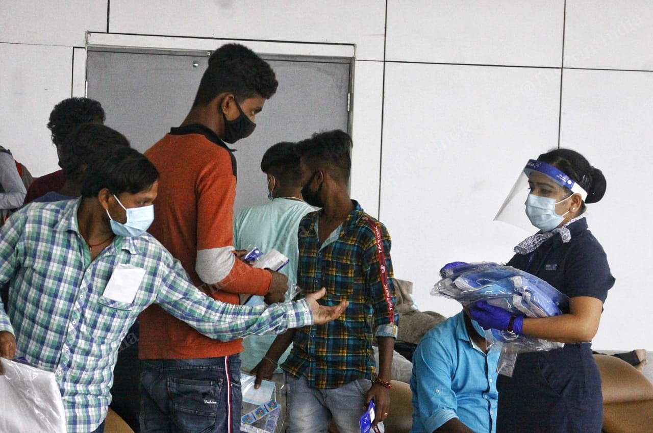 The ground staff of IndiGo distributes face shields and PPE kits. The kits are only given to passengers who will be travelling in the middle seat | Praveen Jain | ThePrint