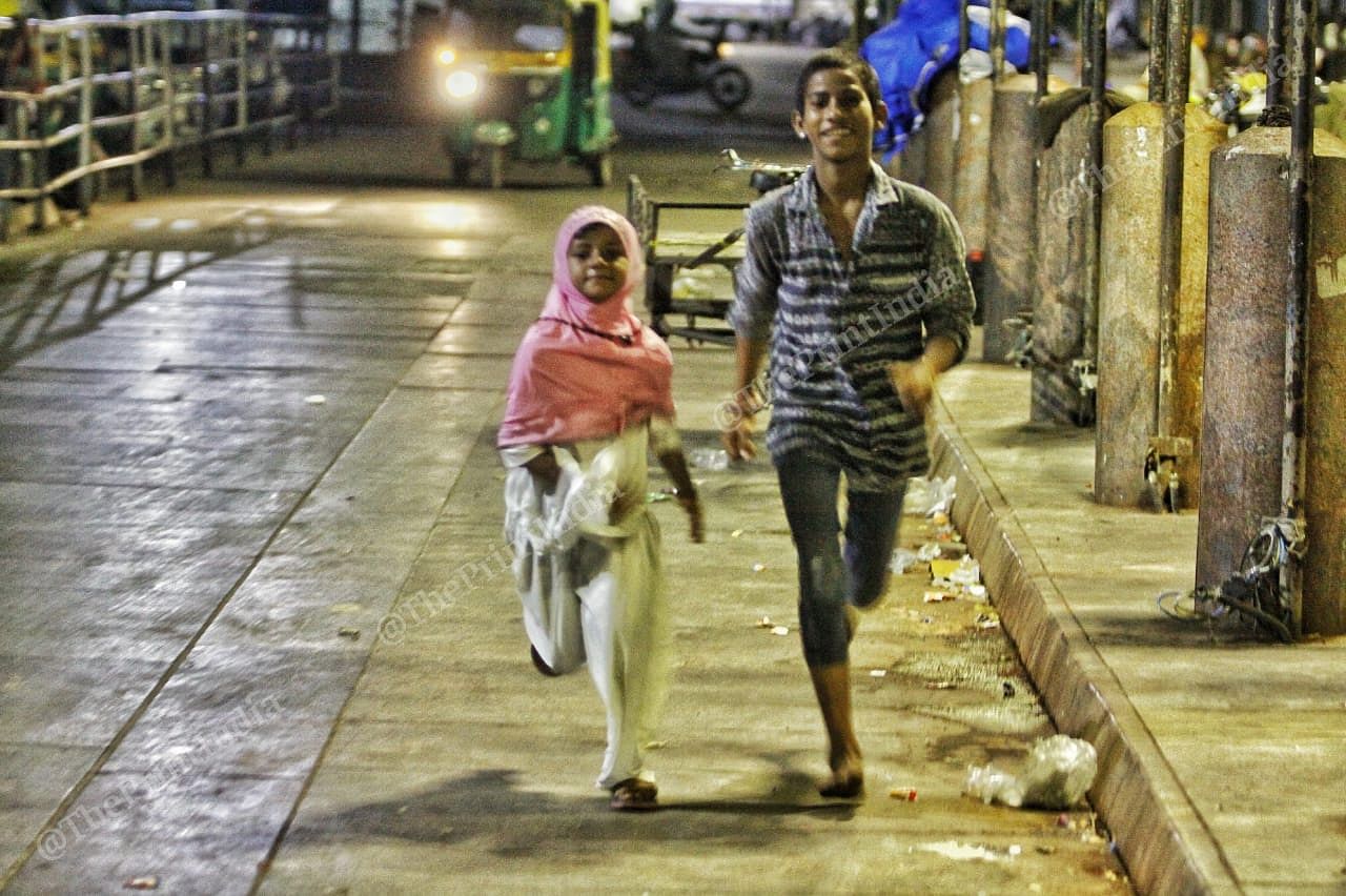 Teen Darwaza, a Gateway completed by Sultan Ahmed Shah, is now a place with lot of eateries. Seen here are children running on the streets at night | Photo: Praveen Jain | ThePrint