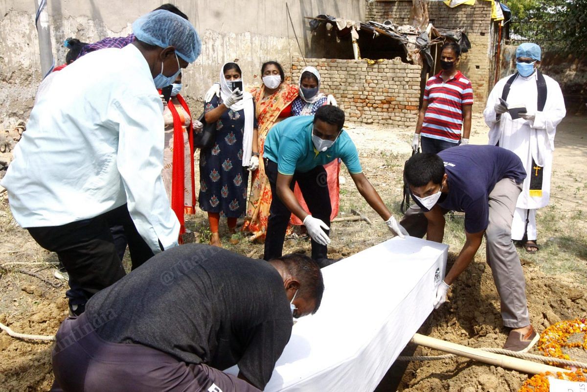 The coffin was lowered into the burial spot. The Mongolpuri cemetery, a designated Covid burial ground, has seen 19 burials so far | Praveen Jain | ThePrint