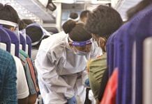 An air hostess wearing a PPE kit gives safety advisory to the passengers | Photo: Praveen Jain | ThePrint