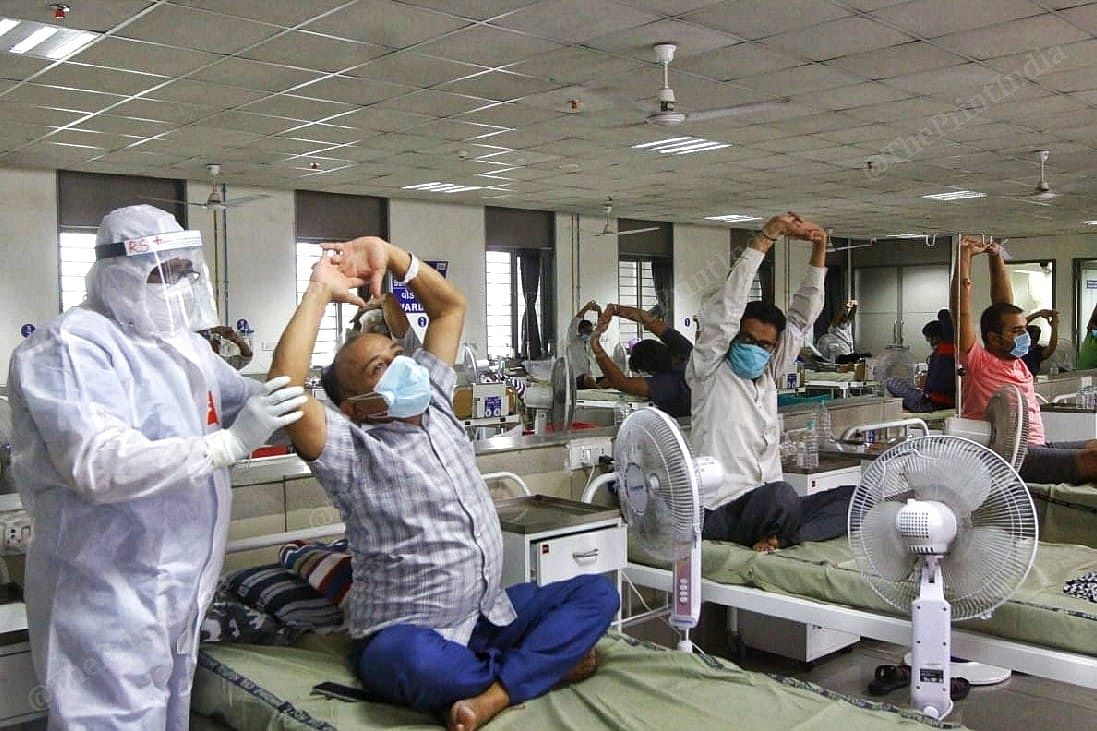 Another doctor helps a Covid-19 patient to stretch better while doing yoga | Photo: Praveen Jain | ThePrint
