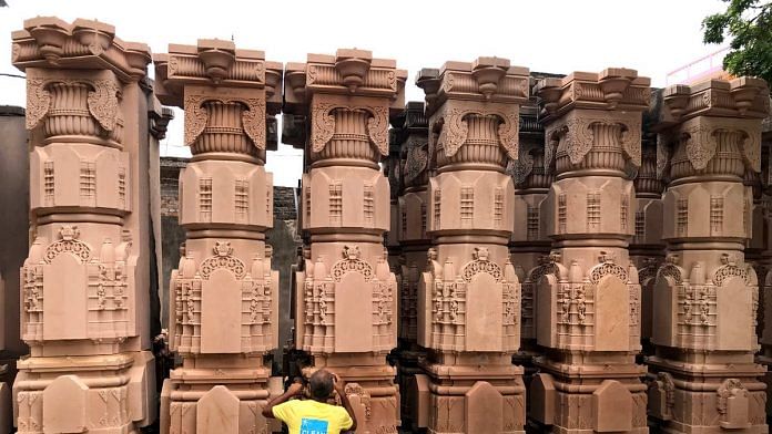 A man cleans carved stones meant to be used in the construction of the Ram Mandir in Ayodhya | Photo: ANI