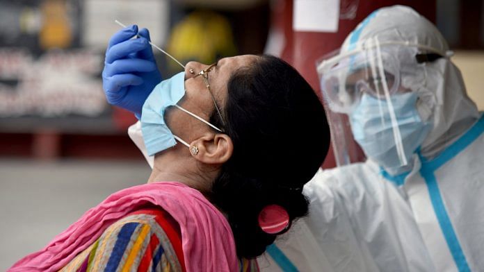 A woman undergoes a Covid-19 test in Delhi | Photo: ANI