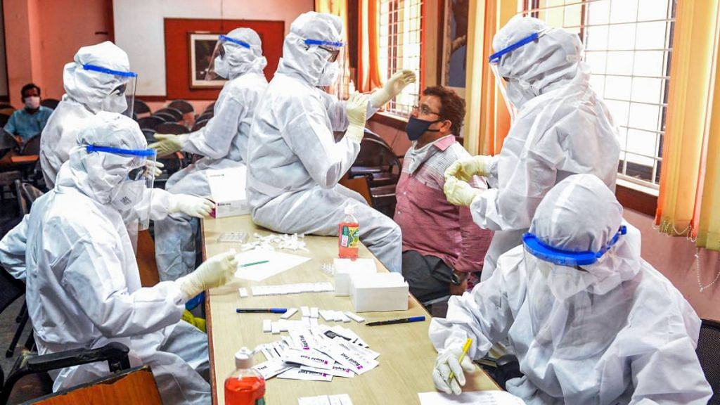 Health workers in PPE kits collect swab samples at a Covid-19 test centre in Palakkad, on 27 July 2020 | PTI
