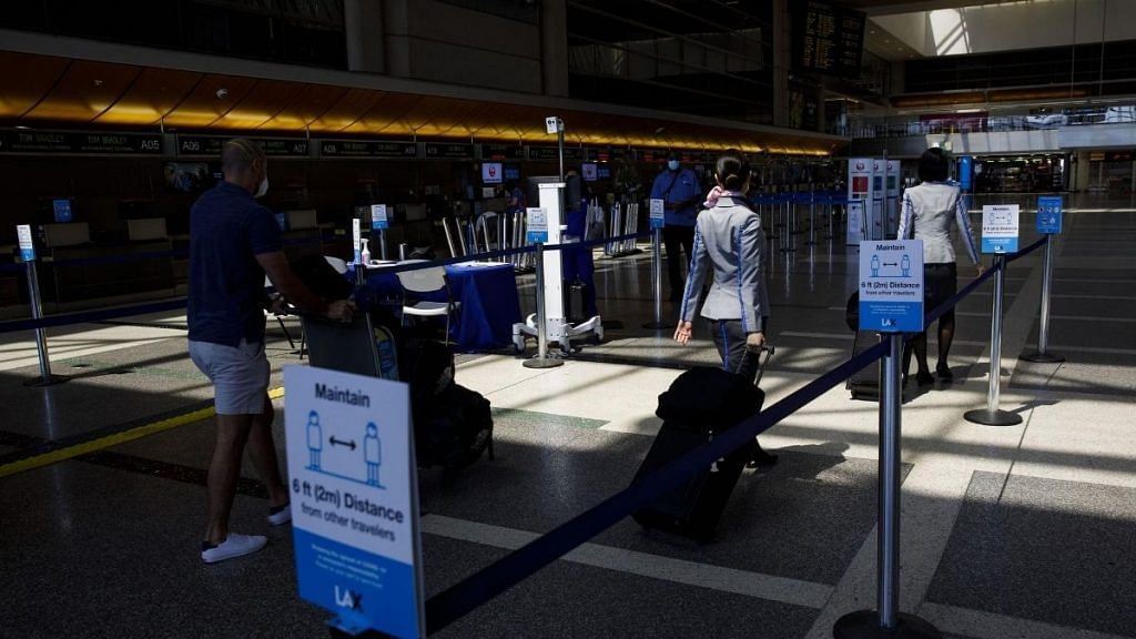 Passengers walk past thermal imaging cameras at Los Angeles International Airport (LAX) | Patrick T. Fallon | Bloomberg