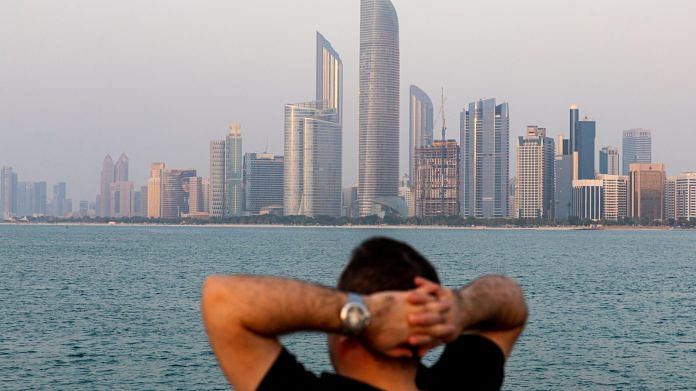 A visitor looks at the view of the city skyline in Abu Dhabi