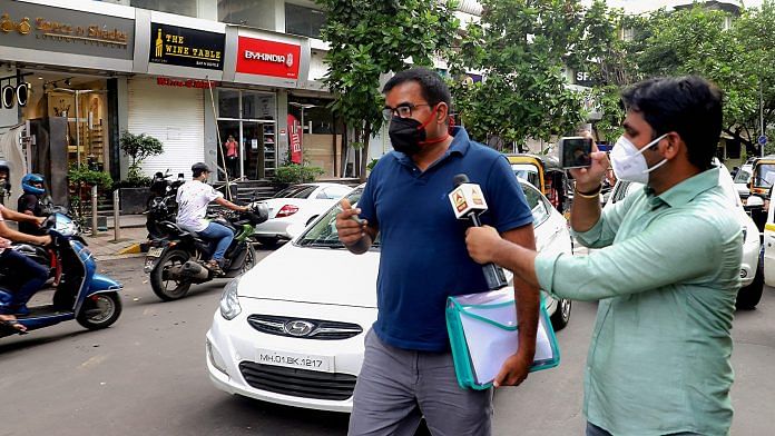 A media personnel attempts to speak to a Bihar policeman, as the latter arrives at a branch of Kotak Bank for investigation in connection to death by suicide case of Bollywood actor Sushant Singh Rajput | PTI