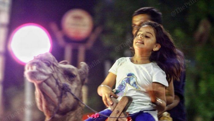 A kid takes a ride on a camel | Photo: Praveen Jain | ThePrint