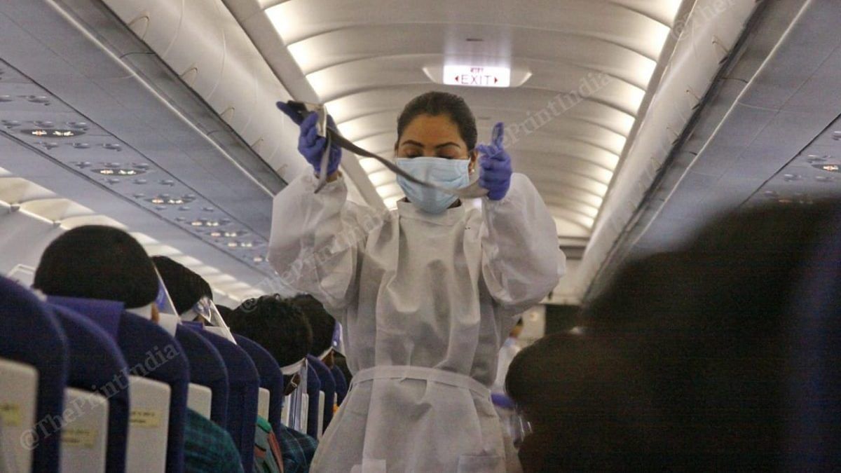 A flight attendant in PPE gear gives safety instructions | Photo: Praveen Jain | ThePrint