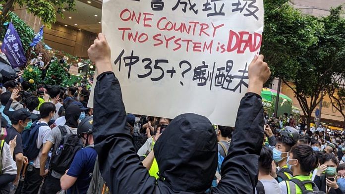A protester holds up a placard during the protests in Hong Kong against China's imposition of the new national security law. | Poebe Kong/ Twitter