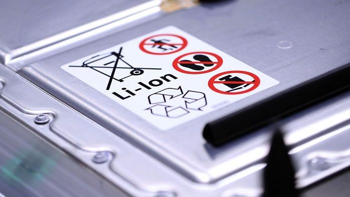 A recycling symbol and handling instructions sit on a lithium-ion automotive battery pack