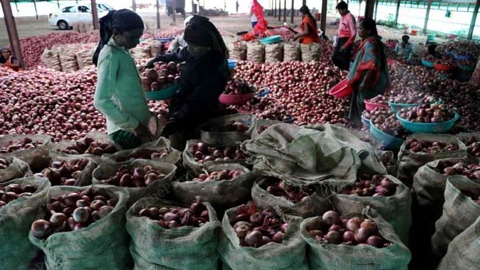Workers at a godown in Manmad, Nashik, pack onions in sacks for export to Bangladesh | Vasant Prabhu | ThePrint