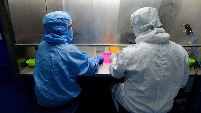 Lab technicians produce Covid-19 diagnostic kits in a laboratory in Faridabad