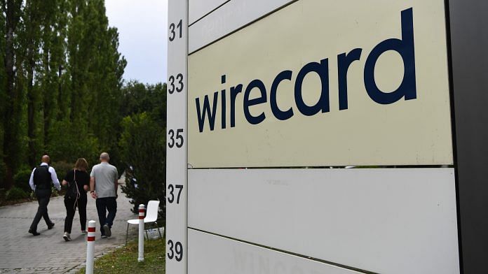 Visitors pass a sign at the entrance to the Wirecard AG headquarters in Munich 25 June