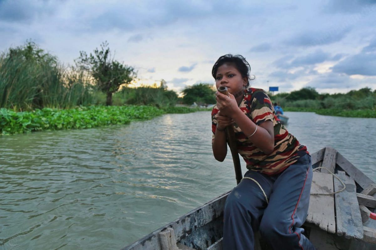 As children grew in the village have to use boats, most of them have learnt how to ride a boat | Photo: Manisha Mondal | ThePrint