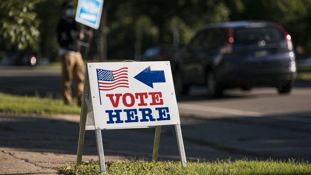 A "Vote Here" sign is displayed outside a polling location in Minneapolis, Minnesota, US | Photographer: Ben Brewer | Bloomberg