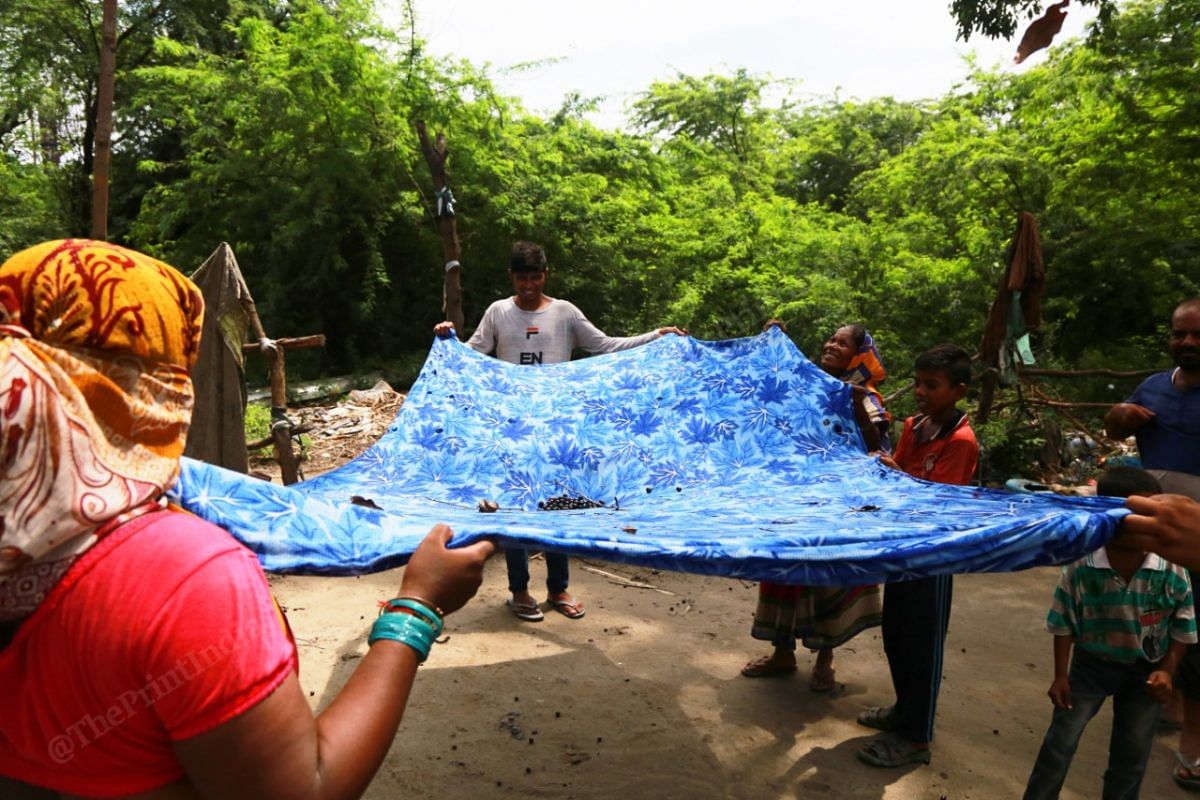 In a blue bedsheet, villagers collect wild plums | Photo: Manisha Mondal | ThePrint