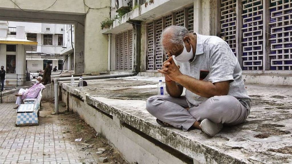 A man who lost a relative in the Shrey Hospital fire is overcome by grief. Despite repeated questions by mediapersons, he did not speak | Photo: Praveen Jain | ThePrint