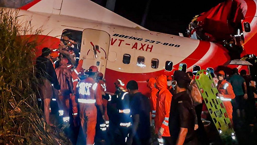 Rescue operation underway after an Air India Express flight with passengers on board en route from Dubai skidded off the runway while landing, at Karippur in Kozhikode | PTI