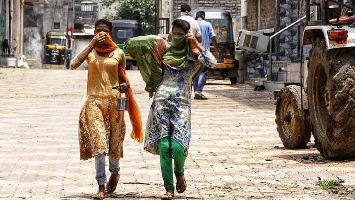Two women cover their faces as they walk through village Jambusar in Bharuch district of Gujarat | Photo: Praveen Jain | ThePrint