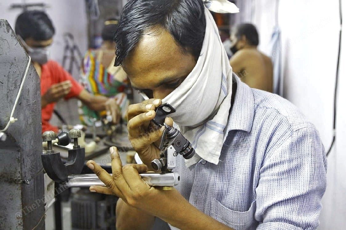 A diamond factory employee inspects a gem | Praveen Jain | ThePrint