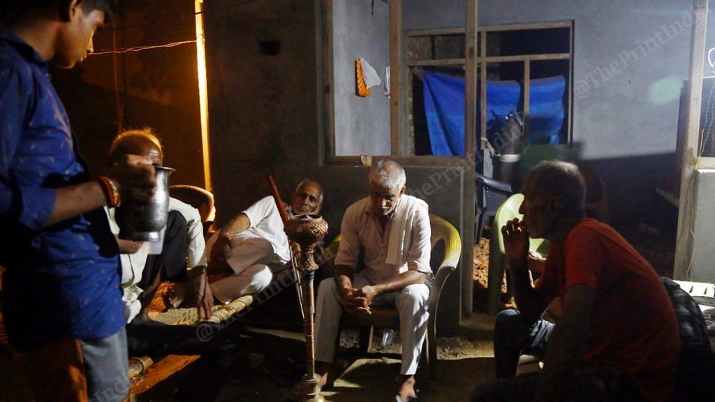 Sudeeksha's grandfather, relatives and other people of Deri Skaner village gather in the Bhatis' compound Tuesday evening | Photo: Suraj Singh Bisht | ThePrint